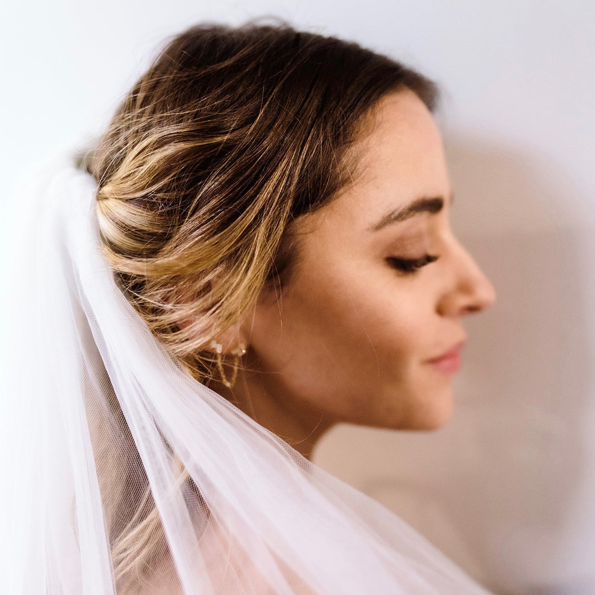 bride with veil and earrings