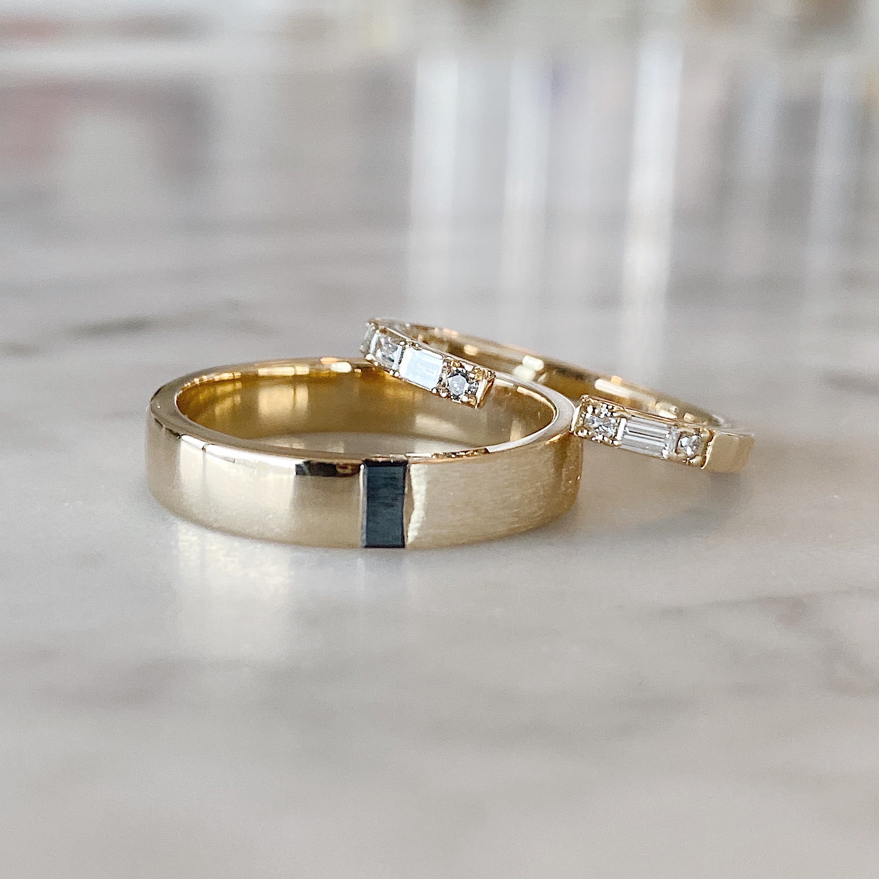 gold diamond rings on table