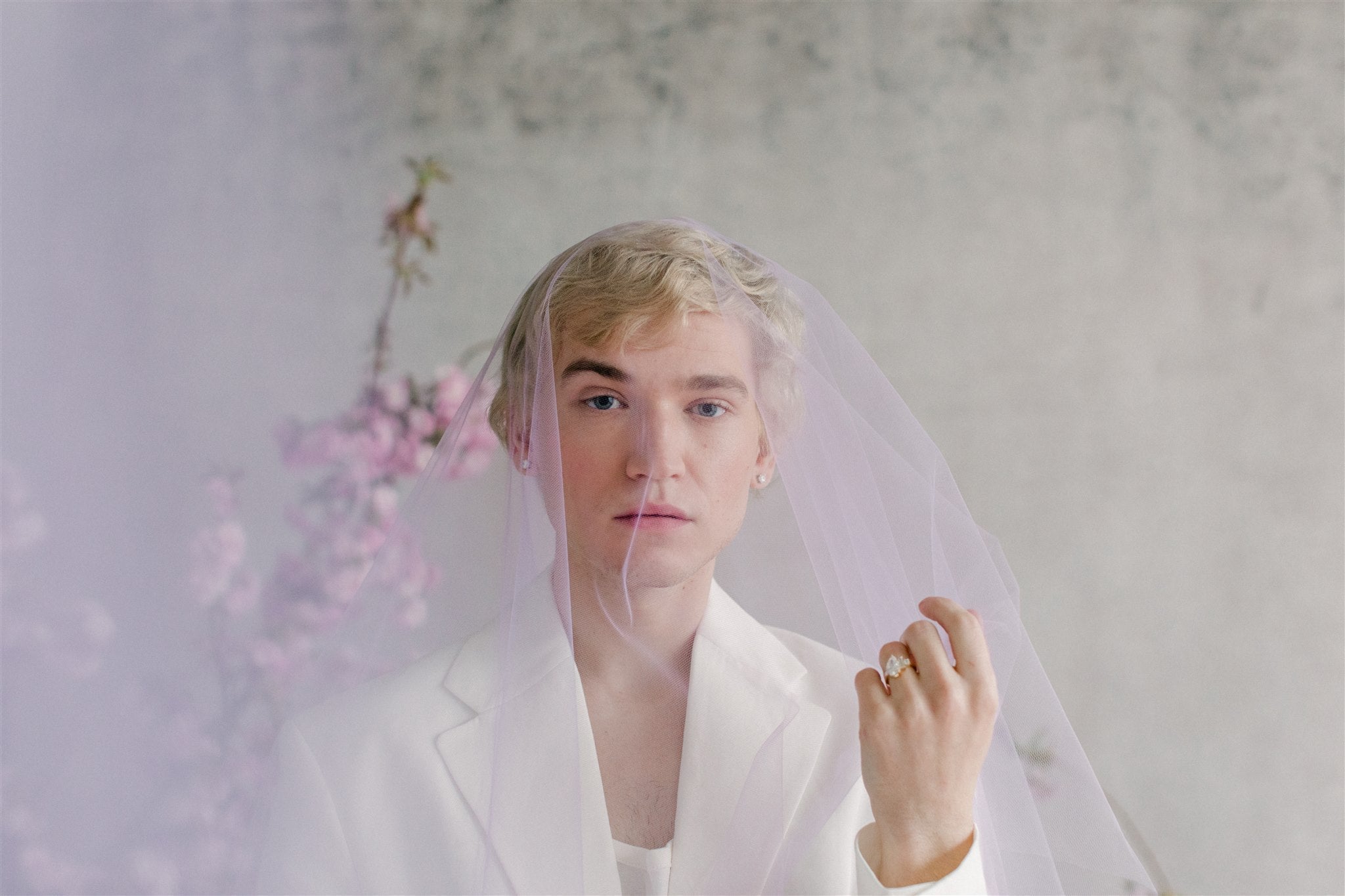 person in white suite and veil