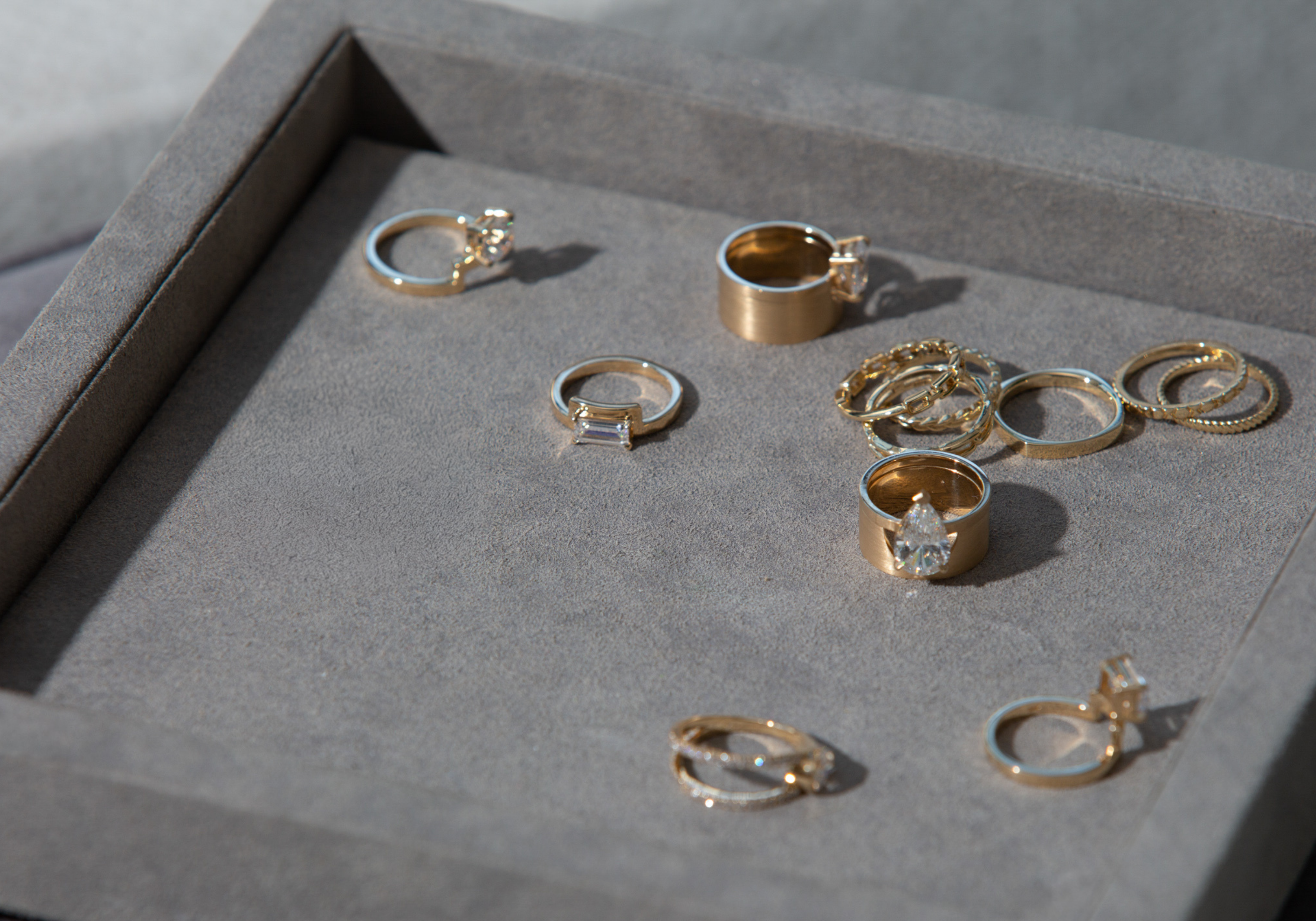 Gold rings displayed on a gray surface