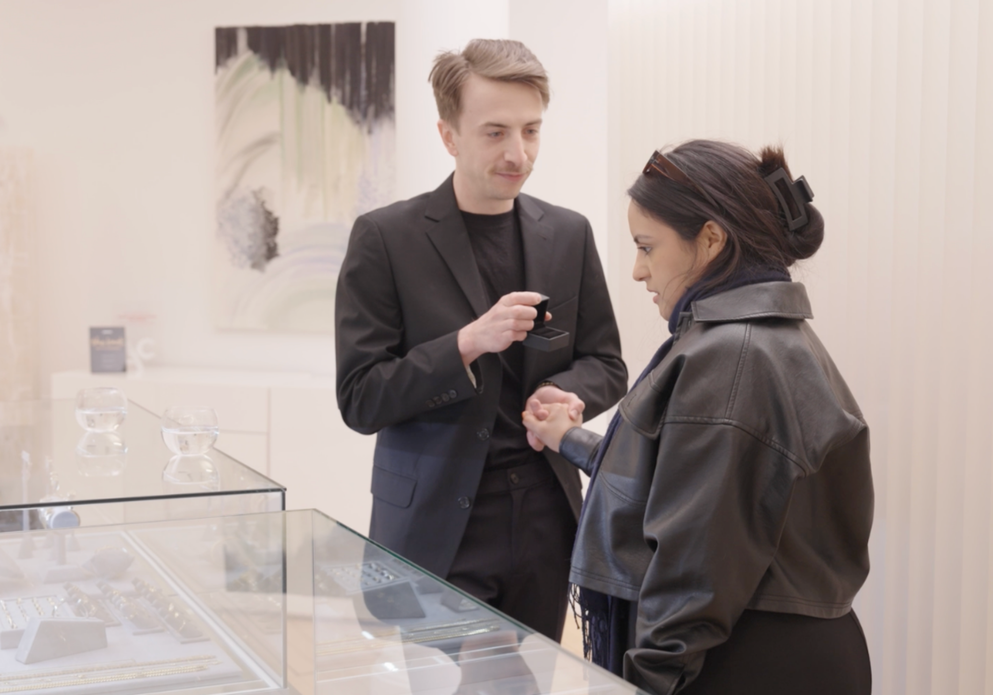 Two people interacting in a jewelry showroom
