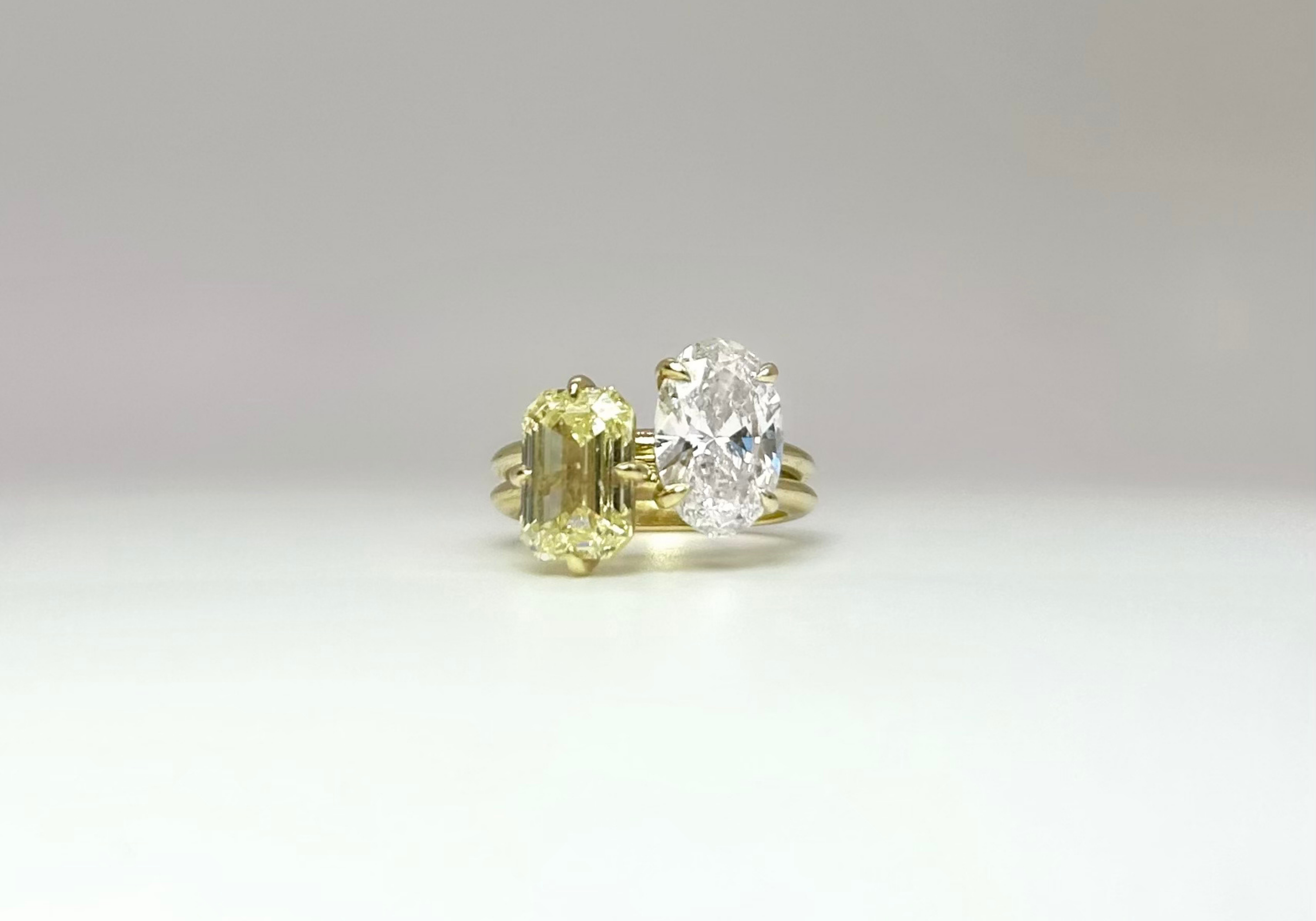 Two diamond rings on a light gray background