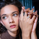 Ring in 14k gold and diamonds by Shahla Karimi on model on dark background