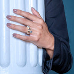 Round Wide Side Set Rivet Engagement Ring by Shahla Karimi on hand on white column
