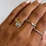 Rings in 14k gold and diamonds by Shahla Karimi on hand on light background