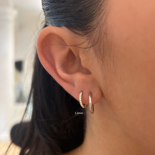 Close-up earing with two hoop earrings with text that reads 12mm