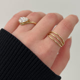 Rings in 14k gold and diamonds by Shahla Karimi on model on light background