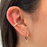 Triangle Earring Charms by Shahla Karimi on ear on light background