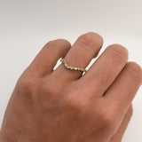 Hand wearing a baguette and round diamond ring with a white background