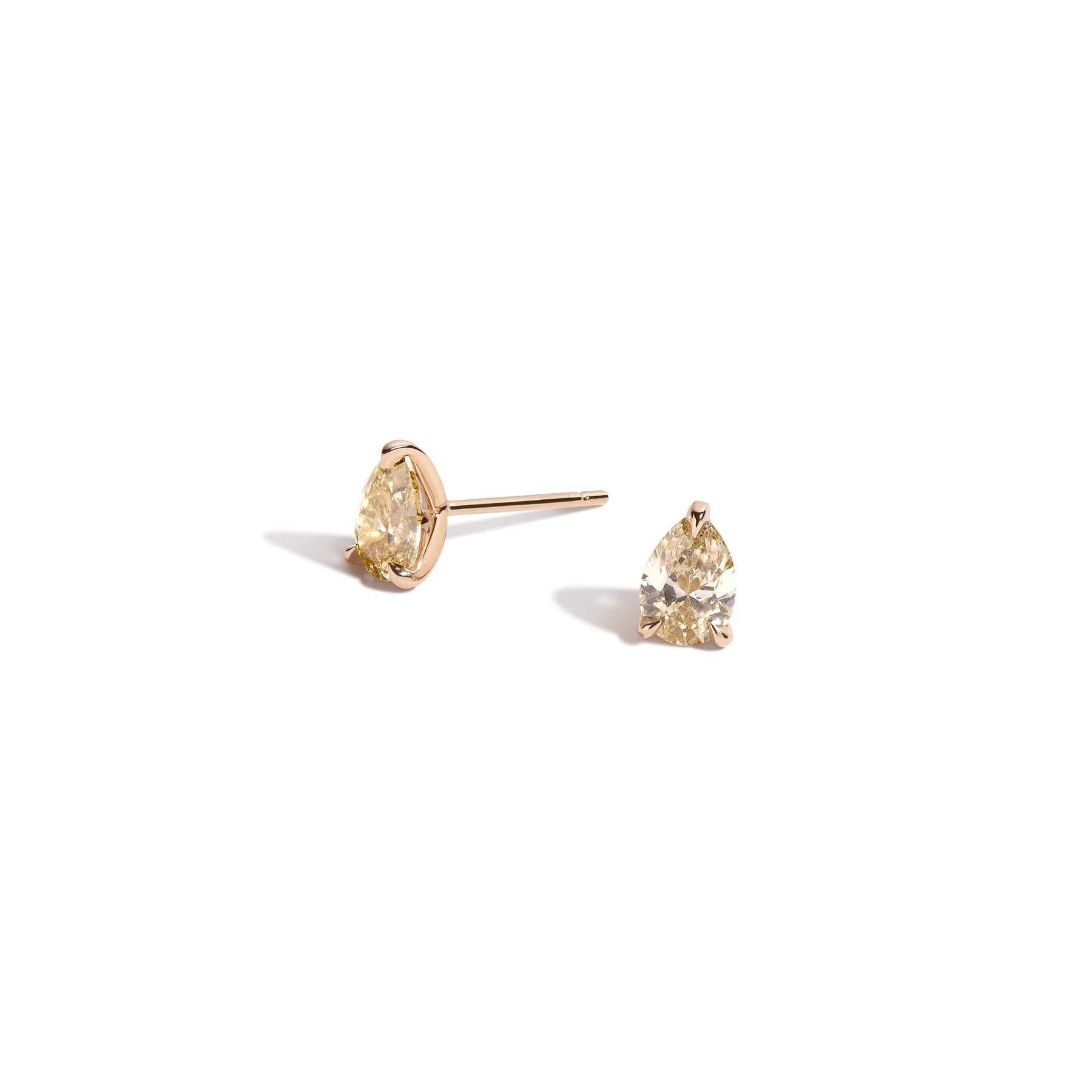Pair of Shahla Karimi pear-cut diamond studs in 14k yellow gold on white background