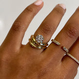 Rings in 14k gold and diamonds by Shahla Karimi on hand on light background