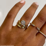 Rings in 14k gold and diamonds by Shahla Karimi on hand on light background