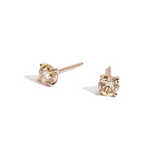 Champagne color round diamond studs in yellow gold on white background