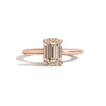 rose gold ring with a champagne emerald-cut diamond on a white background