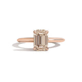 rose gold ring with a champagne emerald-cut diamond on a white background