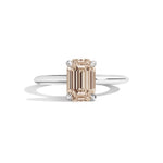 silver ring with a champagne emerald-cut diamond on a white background