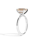 silver ring with a champagne emerald-cut diamond on a white background