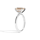 silver ring with a champagne emerald-cut diamond on a white background