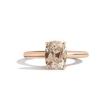Rose gold ring with a brown gemstone on a white background