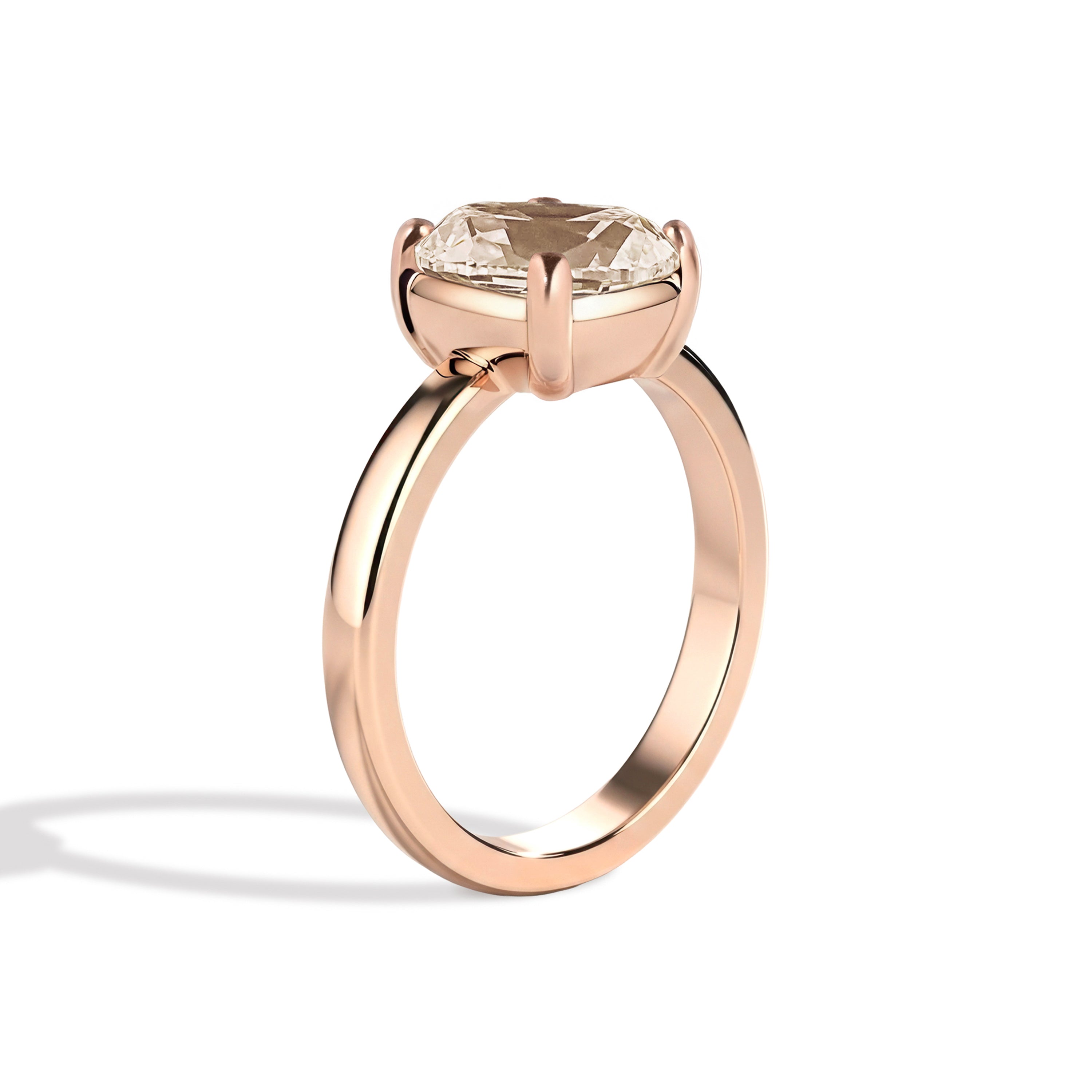 Rose gold ring with a large diamond on a white background
