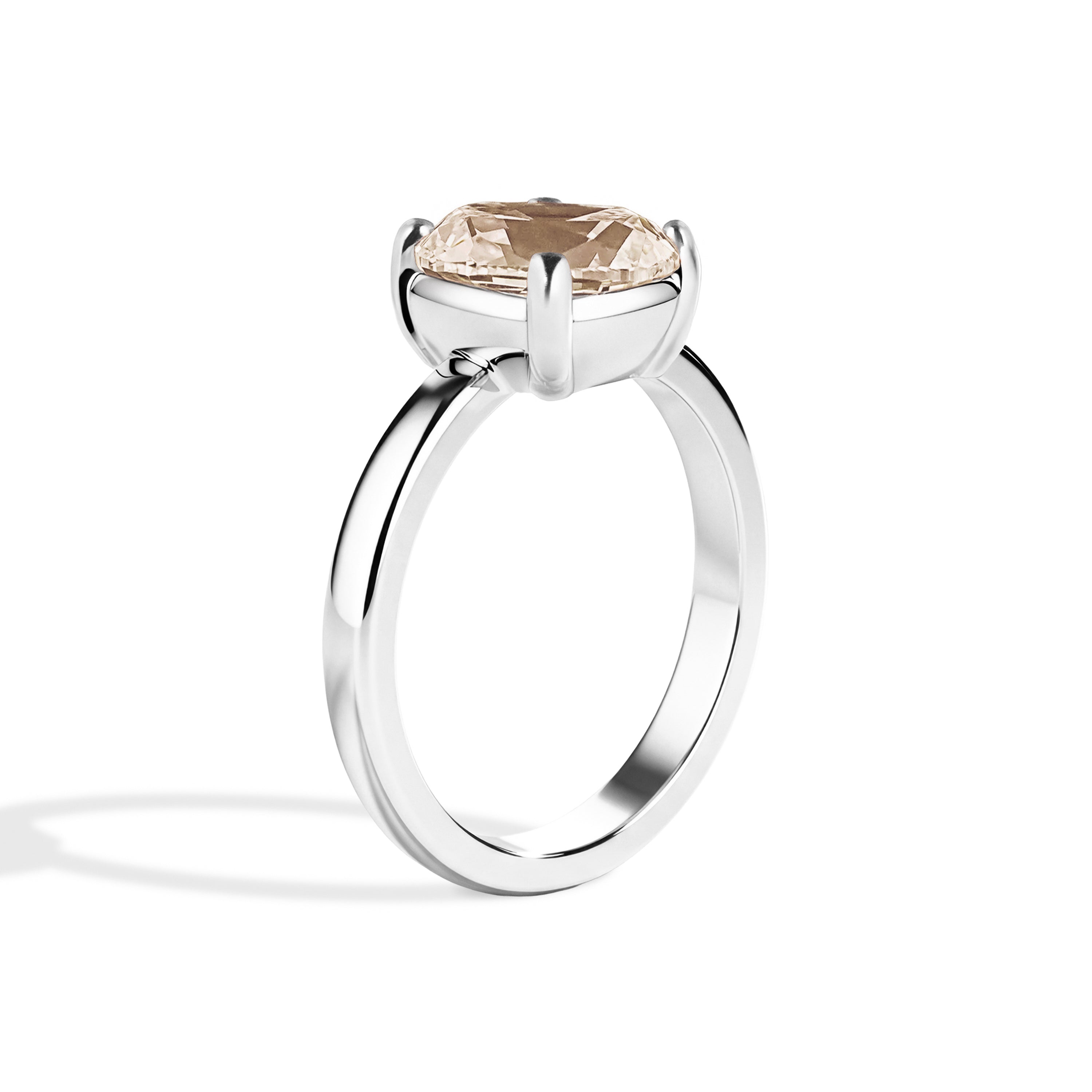 Silver ring with a brown gemstone on a white background