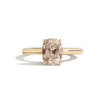 Gold ring with a brown gemstone on a white background