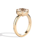  gold ring with a large diamond on a white background