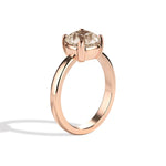 Rose gold ring with a diamond on a white background
