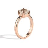 Rose gold ring with a diamond on a white background