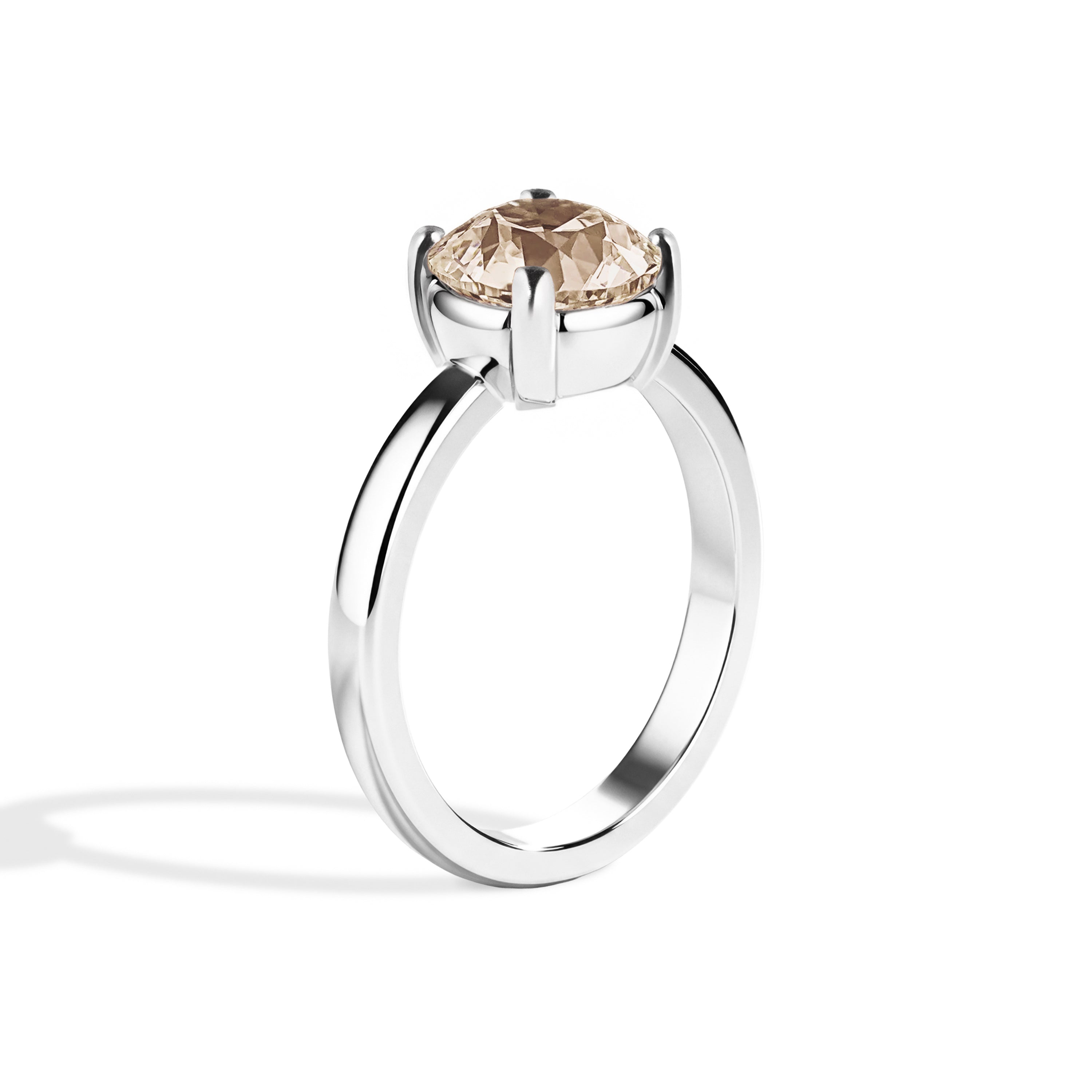 Silver ring with a brown gemstone on a white background