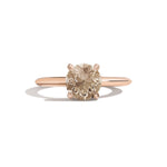 Rose gold ring with a brown gemstone on a white background