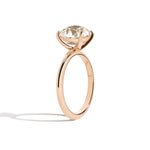Gold ring with a diamond on a white background