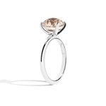 Silver ring with a brown gemstone on a white background