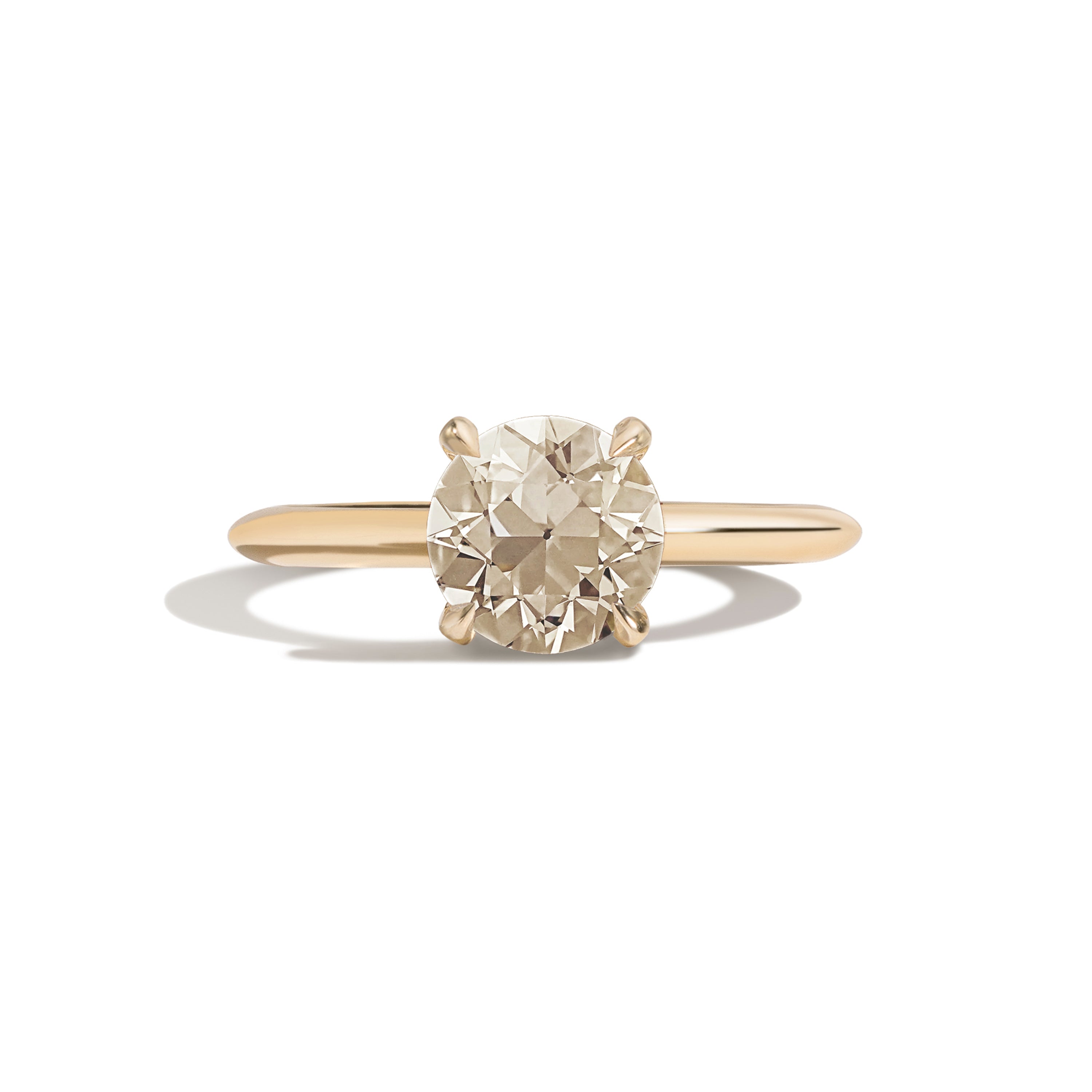 Gold ring with a diamond on a white background