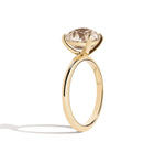 Gold ring with a large diamond on a white background