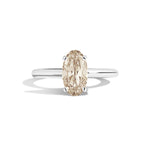 Gold ring with a diamond on a white background