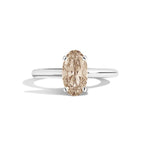 Diamond ring with a brown gemstone on a white background