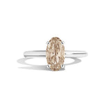 Diamond ring with a brown gemstone on a white background
