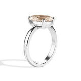 Silver ring with a large gemstone on a white background