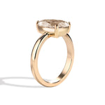 Gold ring with a large diamond on a white background