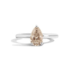 Ring with a pear-shaped brown diamond on a white background