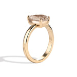 gold ring with a brown diamond on a white background