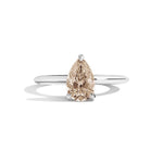 silver ring with a pear-shaped diamond on a white background