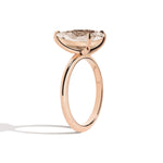 Rose gold ring with a large diamond on a white background