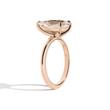 Rose gold ring with a large diamond on a white background