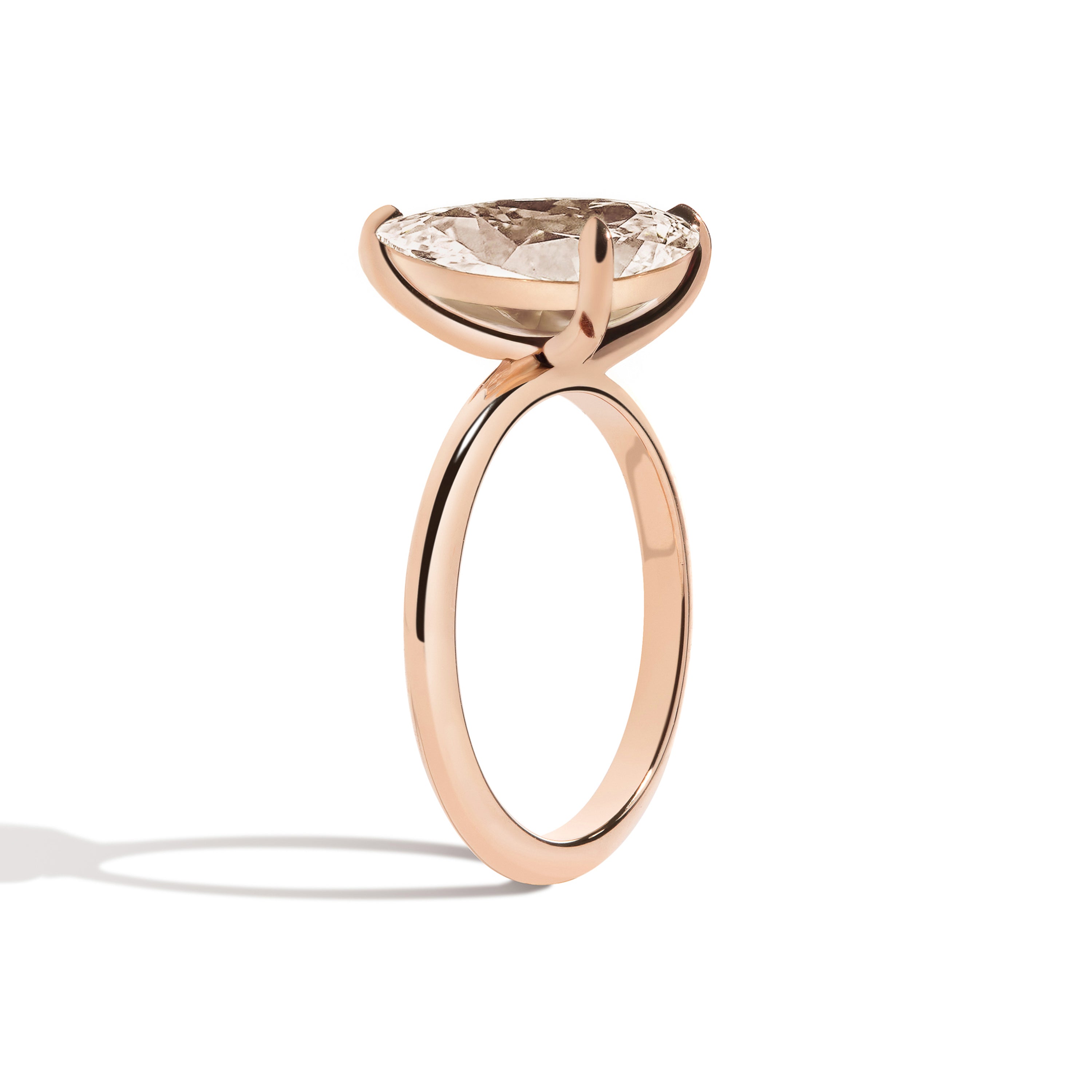 Rose gold ring with a large diamond on a white background
