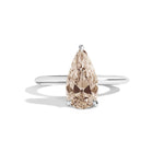 Ring with a pear-shaped brown diamond on a white background