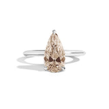 Ring with a pear-shaped brown diamond on a white background