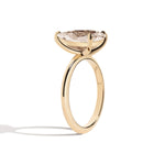 gold ring with a large diamond on a white background