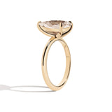 gold ring with a large diamond on a white background